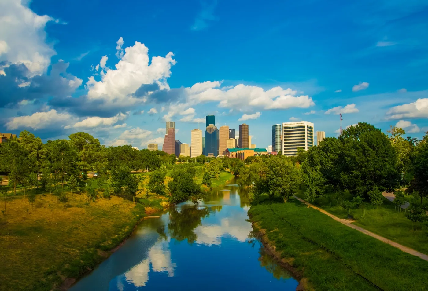 Houston’s downtown skyline above Buffalo Bayou and green parkland